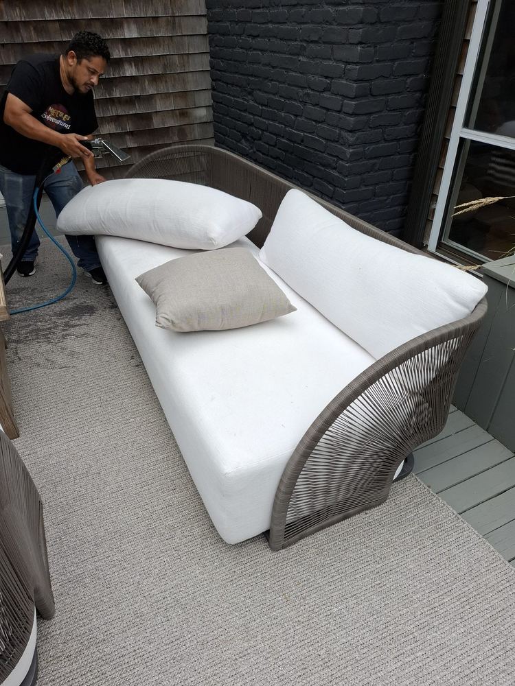 Sofa cushion being extracted at a shingled Long Island house
